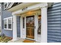 Inviting front entry with decorative pillars and a glass-paneled wooden door at 4517 Central Ave, Indianapolis, IN 46205
