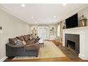 Cozy living room boasts hardwood floors, a fireplace, and built-in shelving at 4517 Central Ave, Indianapolis, IN 46205