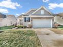 Charming single-Gathering home with a two-car garage and well-manicured lawn at 5003 Lilium Dr, Plainfield, IN 46168