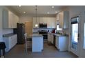 Bright kitchen featuring stainless steel appliances, granite countertops, tiled floor and white cabinets at 5303 Rum Cherry Way, Indianapolis, IN 46237