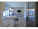 Open concept living room with a gray sofa and view to kitchen island at 5303 Rum Cherry Way, Indianapolis, IN 46237