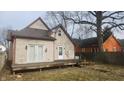 Spacious backyard features a deck and lush greenery, perfect for outdoor entertaining and relaxation at 817 W 5Th St, Anderson, IN 46016