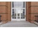 Close up of front doors to the building, featuring glass panels and brick surround at 8751 Jaffa Court E Dr # 17, Indianapolis, IN 46260