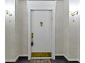 Hallway with a white door with a gold lion door knocker and sconce lights at 8751 Jaffa Court E Dr # 17, Indianapolis, IN 46260