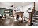 Bright living room featuring a brick fireplace, hardwood floors, and neutral decor at 920 N Chester Ave, Indianapolis, IN 46201