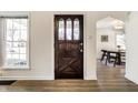Inviting entryway features a dark wood door with glass accents and hardwood floors at 105 N Irwin St, Indianapolis, IN 46219