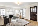 Bright living room with fireplace, large windows, stylish decor, and a cozy seating area at 105 N Irwin St, Indianapolis, IN 46219