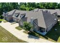Beautiful townhome exterior featuring brick and a well manicured lawn at 1148 Easy St # B, Greenwood, IN 46142