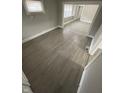 Spacious living room featuring gray wood-look floors and plenty of natural light at 1207 N Kealing Ave, Indianapolis, IN 46201
