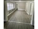 Open-concept living room with wood-look floors and built-in cabinets at 1207 N Kealing Ave, Indianapolis, IN 46201