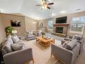 Spacious living room with a brick fireplace, vaulted ceiling, and ample seating, perfect for entertaining at 12840 Patrick Ct, Fishers, IN 46038