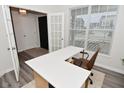 Bright office space boasts a large window, neutral walls, and a modern desk, perfect for remote work at 1307 Peregrine Ln, Greenwood, IN 46143