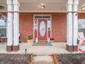 Welcoming front porch with decorative accents and a charming red front door at 13851 N Layton Mills Ct, Camby, IN 46113