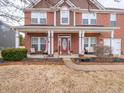 Inviting front porch with a red door, decorated with seasonal accents and comfortable seating at 13851 N Layton Mills Ct, Camby, IN 46113