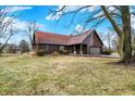 Attractive home featuring wood siding, a red roof, and a spacious front yard at 14304 Adios Pass, Carmel, IN 46032
