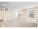 Bright living room featuring new carpet, neutral walls, and recessed lighting at 14344 Cuppola Dr, Noblesville, IN 46060