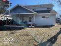 Charming home with a covered front porch, perfect for enjoying the outdoors in a quiet neighborhood at 1437 E Pleasant Run Pkwy S Dr, Indianapolis, IN 46203