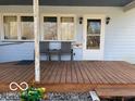 Inviting covered porch with seating, creating a cozy and welcoming entrance to the home at 1437 E Pleasant Run Pkwy S Dr, Indianapolis, IN 46203