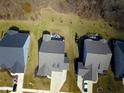 An aerial view of homes showing roof lines, garages, yards, and driveway of each home at 14904 Tiago Ln, Fishers, IN 46040