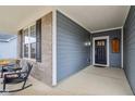 Cozy front porch with rocking chairs, brick accents, and a view of the front door at 14904 Tiago Ln, Fishers, IN 46040
