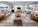 Bright living room featuring neutral tones, plush seating and a cozy fireplace at 15138 Silver Charm Dr, Noblesville, IN 46060