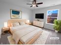 Stylishly staged bedroom with a ceiling fan, natural light and minimalist décor at 15138 Silver Charm Dr, Noblesville, IN 46060
