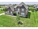 Beautiful two-story home with brick and stone exterior and manicured lawn at 15694 Provincial Ln, Fishers, IN 46040