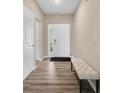 Inviting foyer with bench and durable flooring leading into the home at 1692 S Centennial Ave, New Palestine, IN 46163