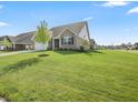 Landscaped front lawn and inviting facade make for great curb appeal at 1692 S Centennial Ave, New Palestine, IN 46163