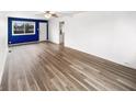 Spacious living room featuring light wood floors, a ceiling fan, and ample natural light at 17 Crestview Dr, Greenwood, IN 46143