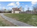 Exterior side view of the house with partial fencing and green lawn at 17879 Sandy Run Ct, Noblesville, IN 46062