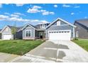 Attractive single-Gathering home with a two-car garage, lush lawn, and concrete driveway, perfect for suburban living at 19714 Highclere Ln, Sheridan, IN 46069