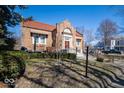 Charming brick home with a well-kept lawn, red roof, attractive front entry, and mature landscaping at 198 E Madison St, Franklin, IN 46131