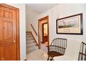 Bright foyer with tile flooring, a staircase, and a wooden bench beneath a decorative painting at 226 Sandbrook Cir, Noblesville, IN 46062