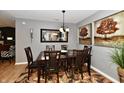 Elegant dining room with a wooden table set, chandelier lighting, neutral wall colors, and decorative accents at 2456 N Willow Way, Indianapolis, IN 46268