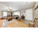 Cozy living room featuring hardwood floors, large windows, and comfortable seating. The area is bathed in natural light at 412 Tulip Dr, Mooresville, IN 46158