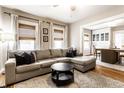 Comfortable living room featuring a sectional sofa, round coffee table, and two bright windows at 5432 Winthrop Ave, Indianapolis, IN 46220