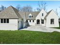 Charming white brick home with well-maintained lawn and front-facing garage for a welcoming view at 580 Exmoor Dr, Carmel, IN 46032