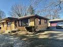Lovely brick home featuring a detached garage, convenient driveway, and well-kept yard space at 6346 Shelby St, Indianapolis, IN 46227
