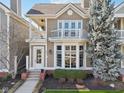 Charming two-story home featuring a private balcony, bay window, and beautifully landscaped front yard at 645 Ellsworth St, Indianapolis, IN 46202