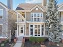 Charming two-story home featuring a private balcony, bay window, and beautifully landscaped front yard at 645 Ellsworth St, Indianapolis, IN 46202