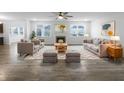 Bright living room with neutral furniture, a cozy fireplace, and ample natural light from large windows at 6457 Flag Stop Dr, Whitestown, IN 46075