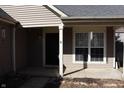 Inviting front door and cozy porch create a welcoming entrance to the home at 6468 Oyster Key Ln, Plainfield, IN 46168