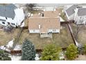 An aerial view showcases the backyard of the house, featuring a screen porch and landscaping at 10120 Youngwood Ln, Fishers, IN 46038