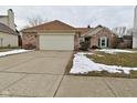 A well-maintained house featuring a brick facade, green window shutters, and an attached garage at 10120 Youngwood Ln, Fishers, IN 46038