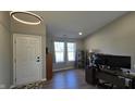 Inviting entryway with a modern light fixture, high ceilings, and wood-look floors at 10645 Aspen Dr, Fishers, IN 46037