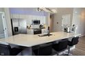 Open-concept kitchen featuring a large center island with seating and stainless steel appliances at 10645 Aspen Dr, Fishers, IN 46037