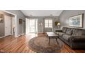 Cozy living room with hardwood floors, a comfortable sofa, and ample natural light at 1114 Northfield Ln, Anderson, IN 46011