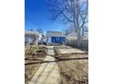 Exterior backyard with a view of the blue home, featuring a small patch of grass and concrete at 1206 Dawson St, Indianapolis, IN 46203