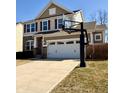 Charming two-story home with stone accents, two car garage and basketball hoop at 12461 Hawks Landing Dr, Fishers, IN 46037